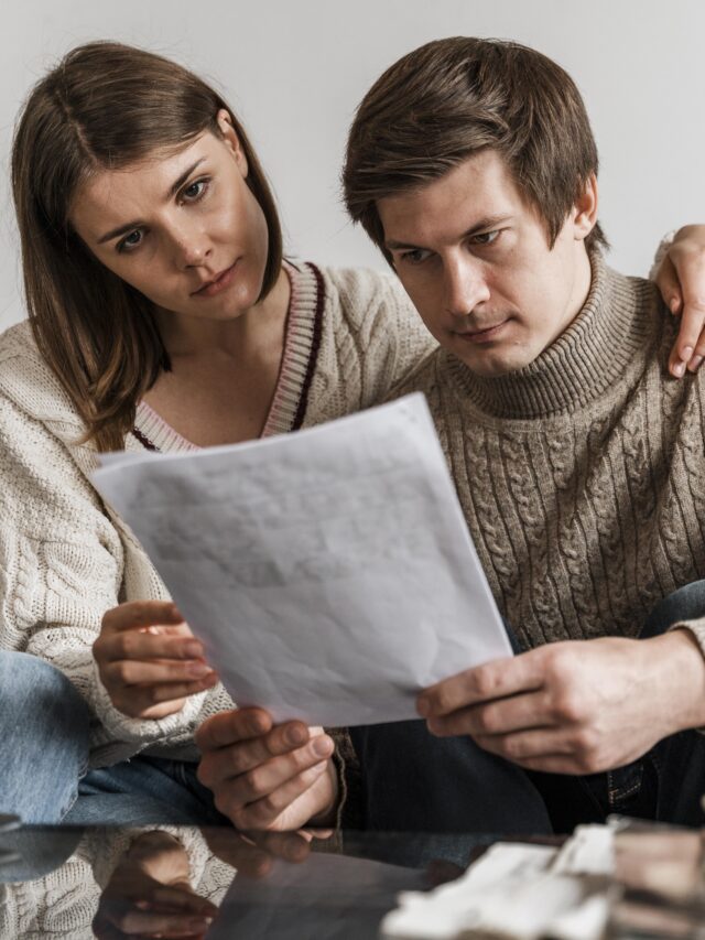close-up-couple-reading-document