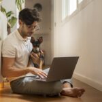 person-working-from-home-with-pet-dog